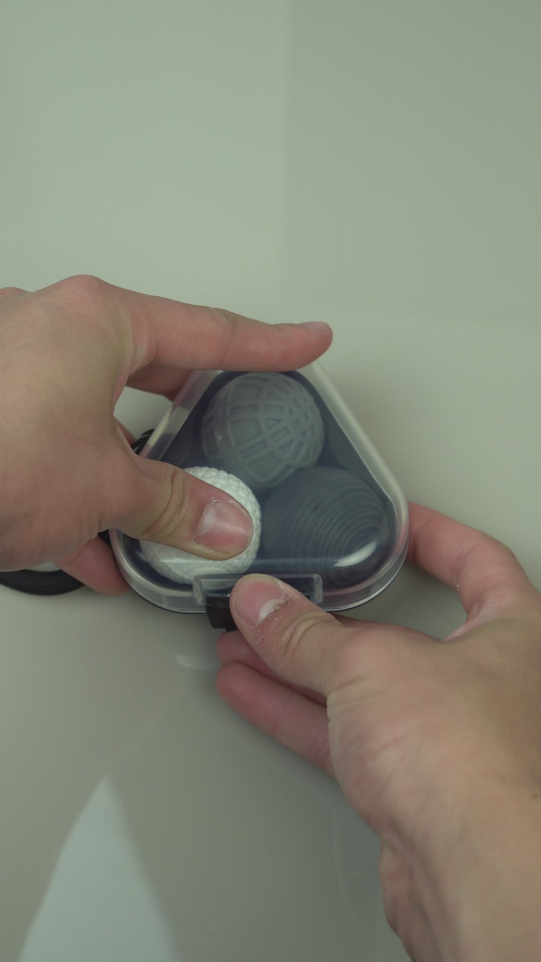 Textured magnetic fidget balls rolling and snapping together silently in hand